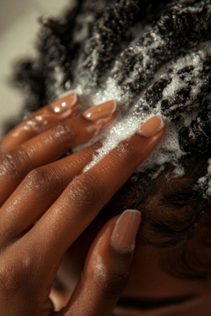 Close-up of coily hair being deeply conditioned