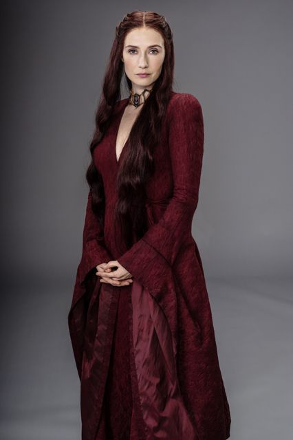 Melisandre with long, flame-colored hair symbolizing her mystical connection to R’hllor, the Lord of Light.