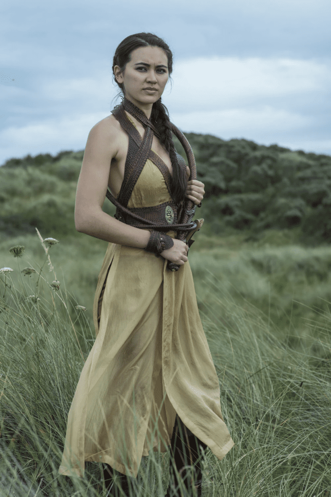 Nymeria Sand showcasing elaborate Dornish braids representing passion and cultural pride.